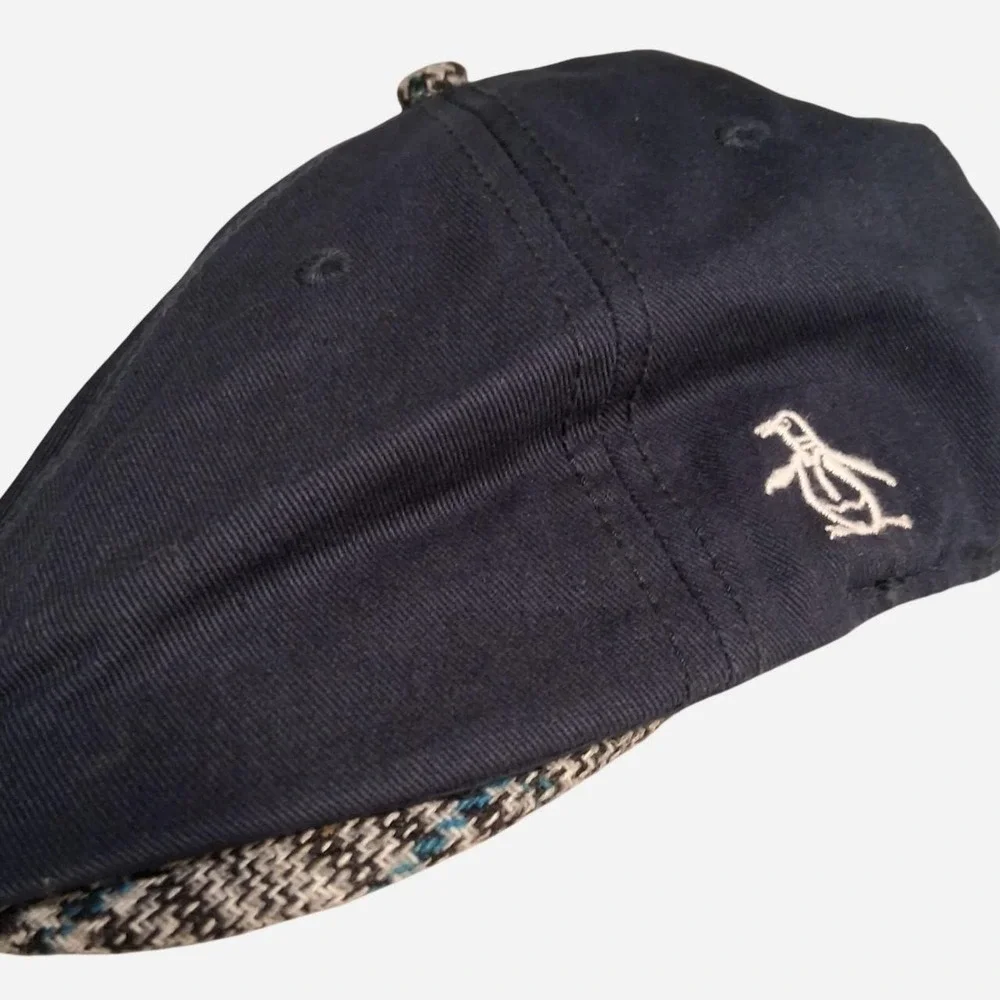 Mens Navy blue flat cap with white penguin logo plaid detail under brim